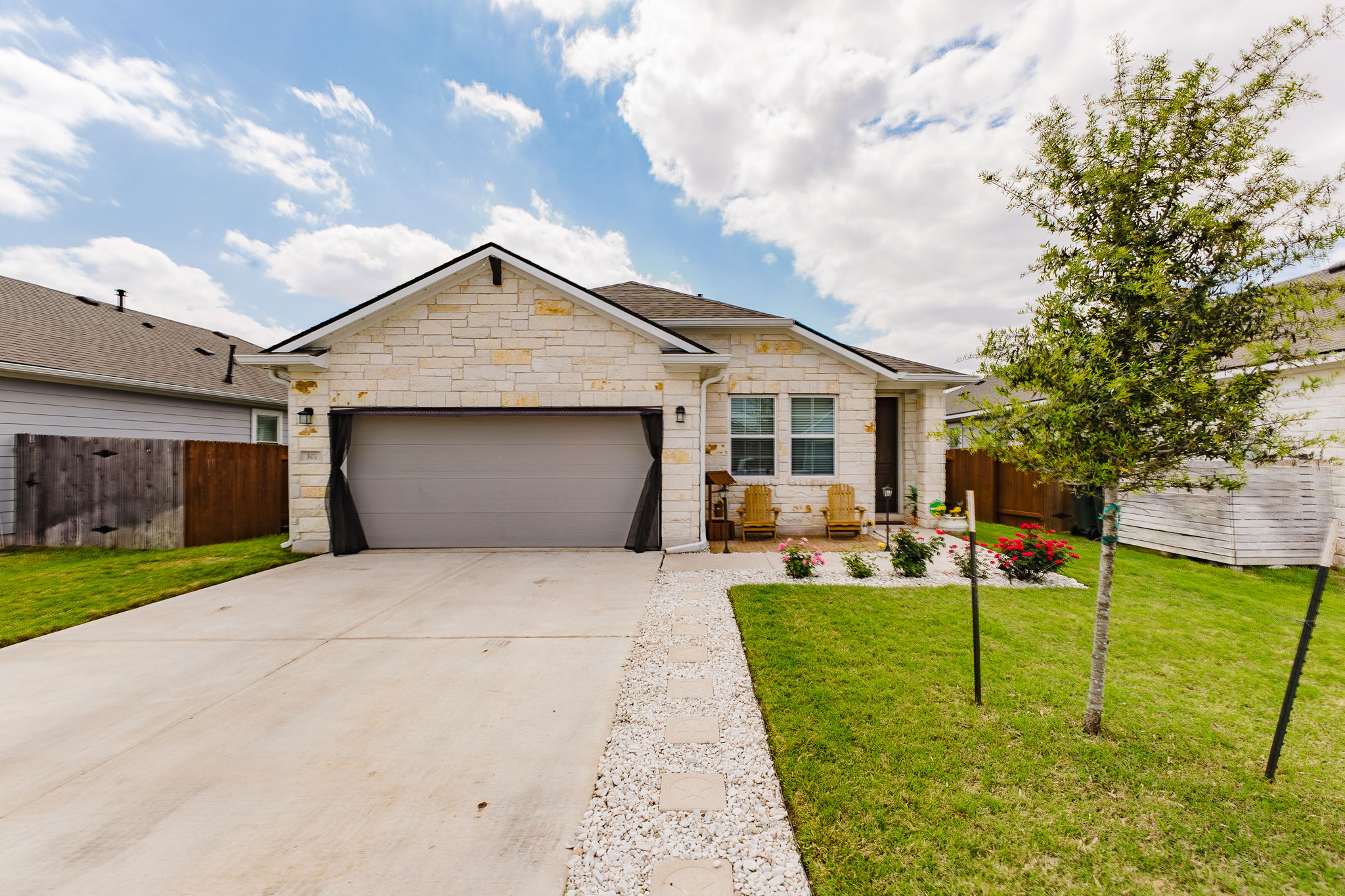 307 Watercourse Way Bastrop, TX 78602 - Photo 2 of 35 a front view of house with yard and green space