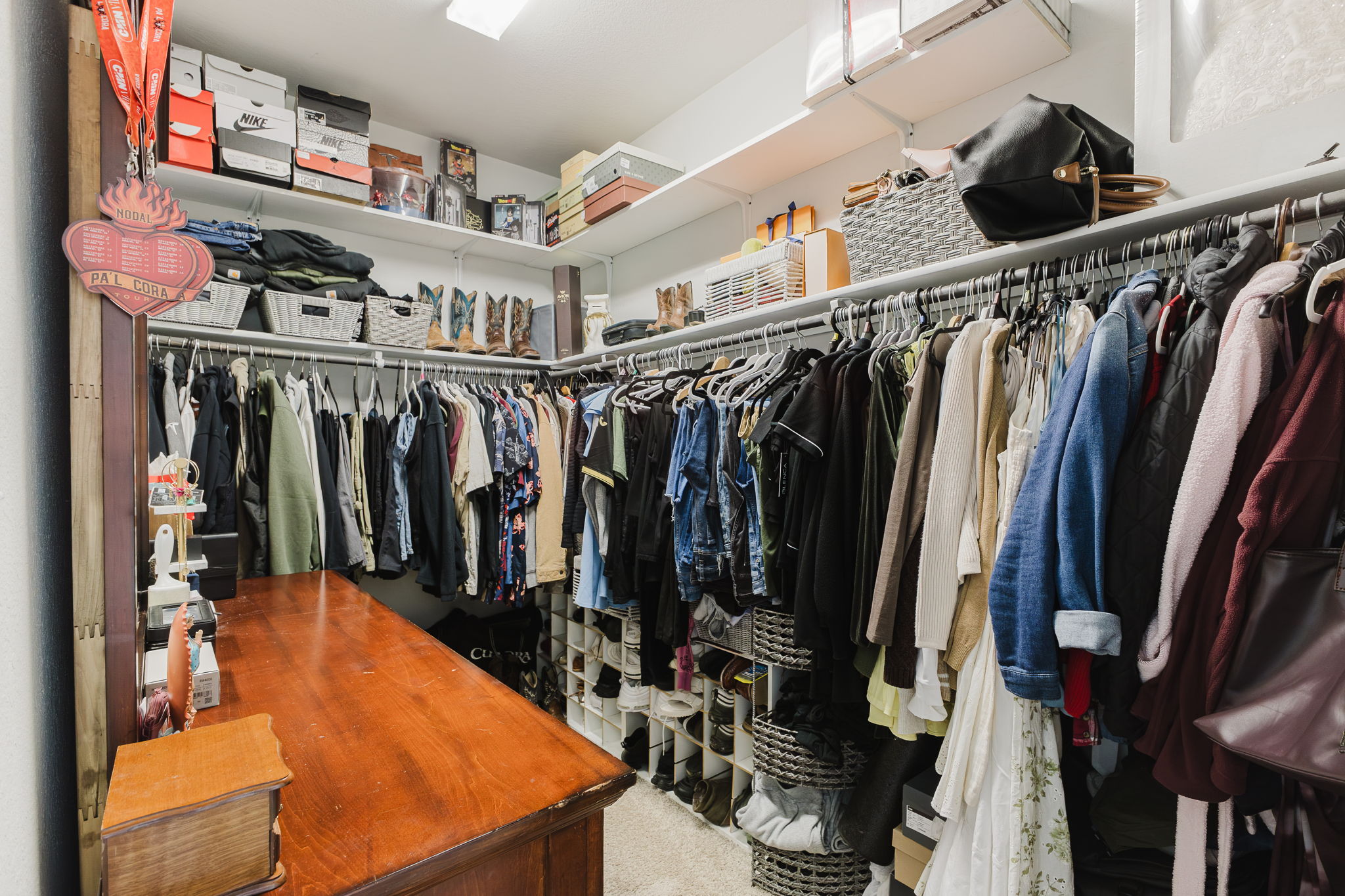307 Watercourse Way Bastrop, TX 78602 - Photo 21 of 35 a view of walk in closet with clothes and shoes