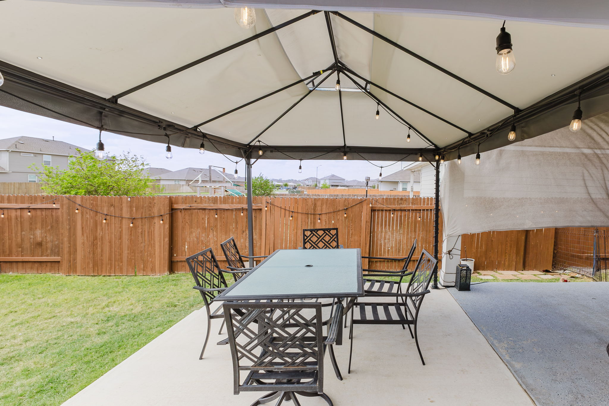 307 Watercourse Way Bastrop, TX 78602 - Photo 24 of 35 a view of a patio with a table and chairs under an umbrella