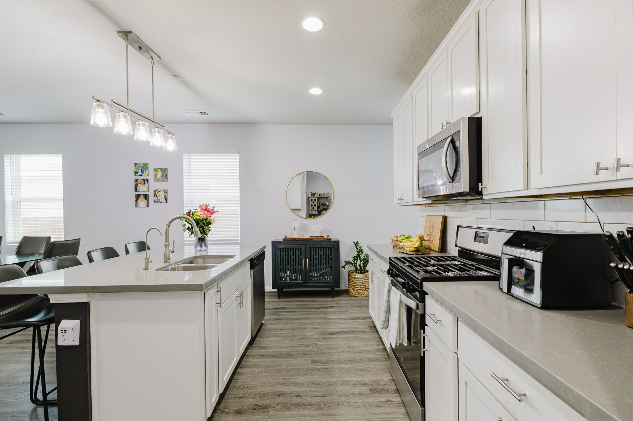 307 Watercourse Way Bastrop, TX 78602 - Photo 5 of 35 a kitchen with a sink stove and cabinets