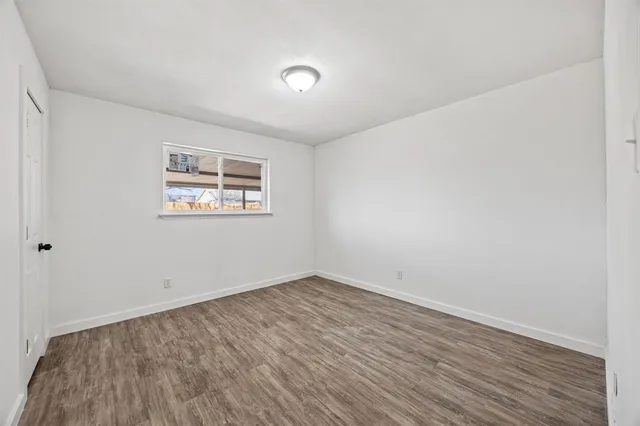 an empty room with a workspace and a window