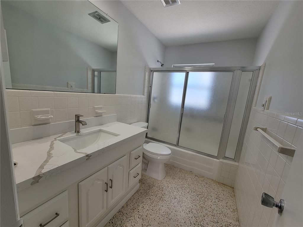 1732 Boca Raton Court Punta Gorda, FL 33950 - Photo 54 of 64 a bathroom with a double vanity sink mirror and toilet