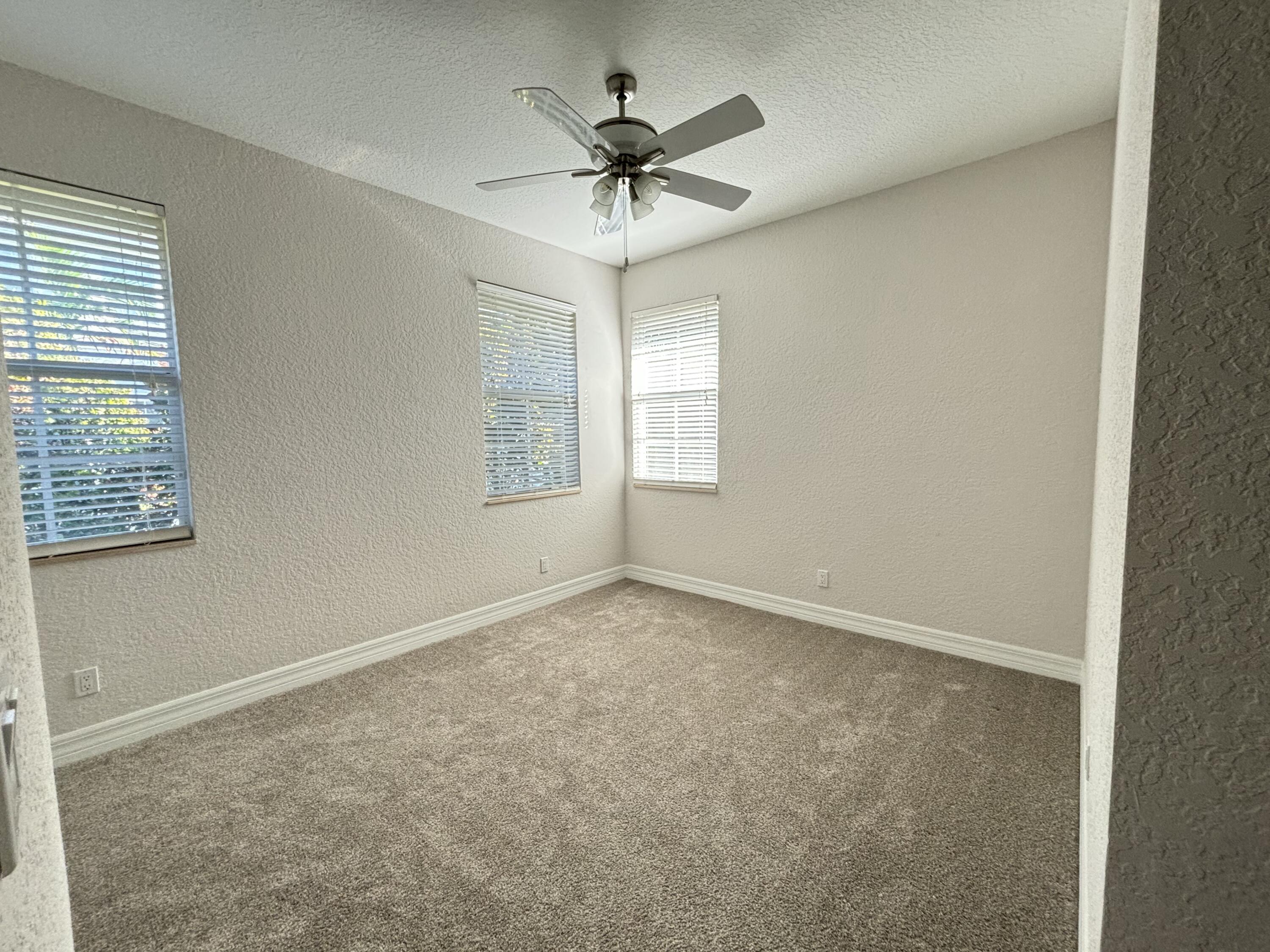 909 Northwest 18th Avenue Boca Raton, FL 33431 - Photo 11 of 39 an empty room with a ceiling fan and window