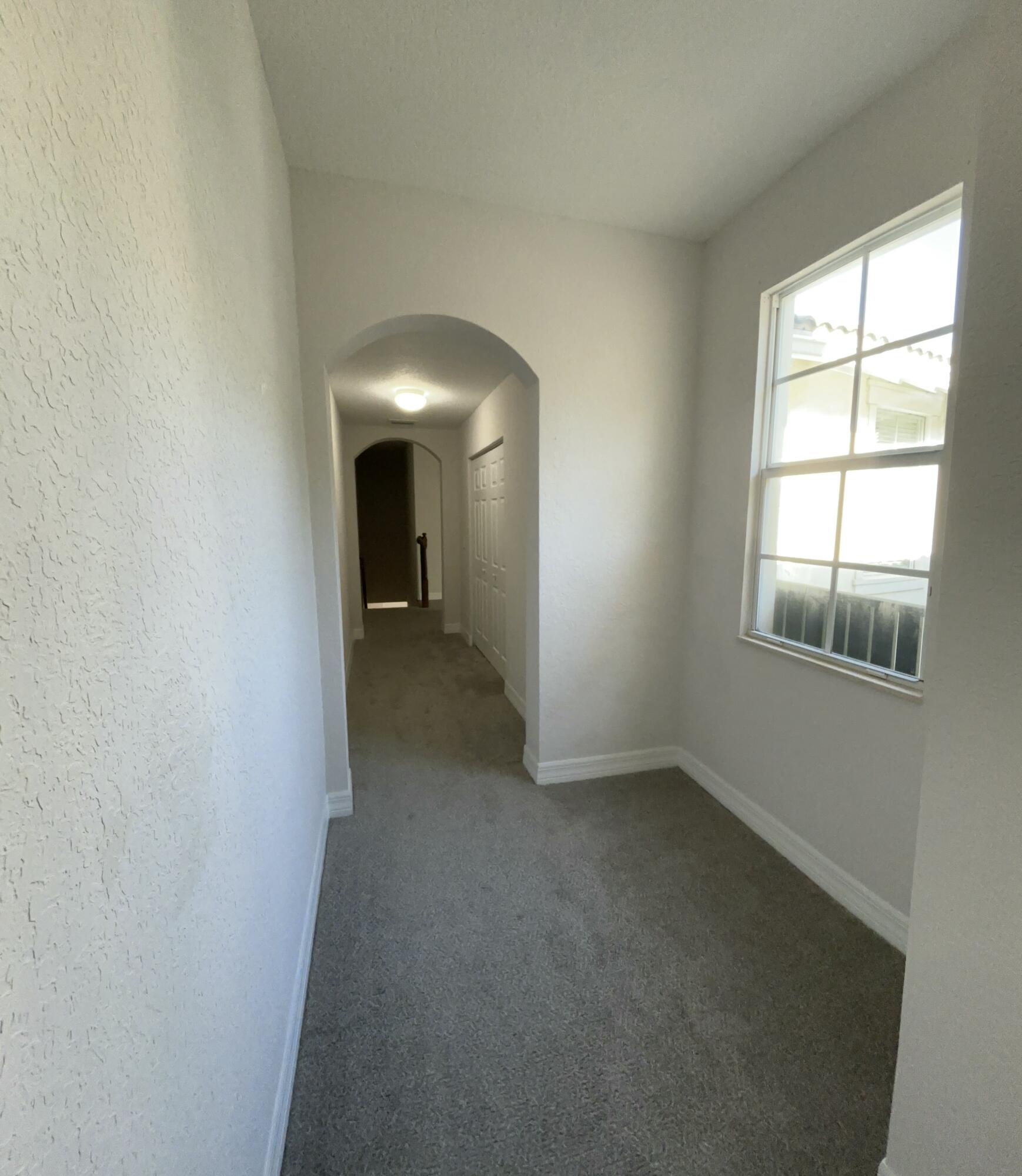 909 Northwest 18th Avenue Boca Raton, FL 33431 - Photo 21 of 39 an empty room with windows and closet