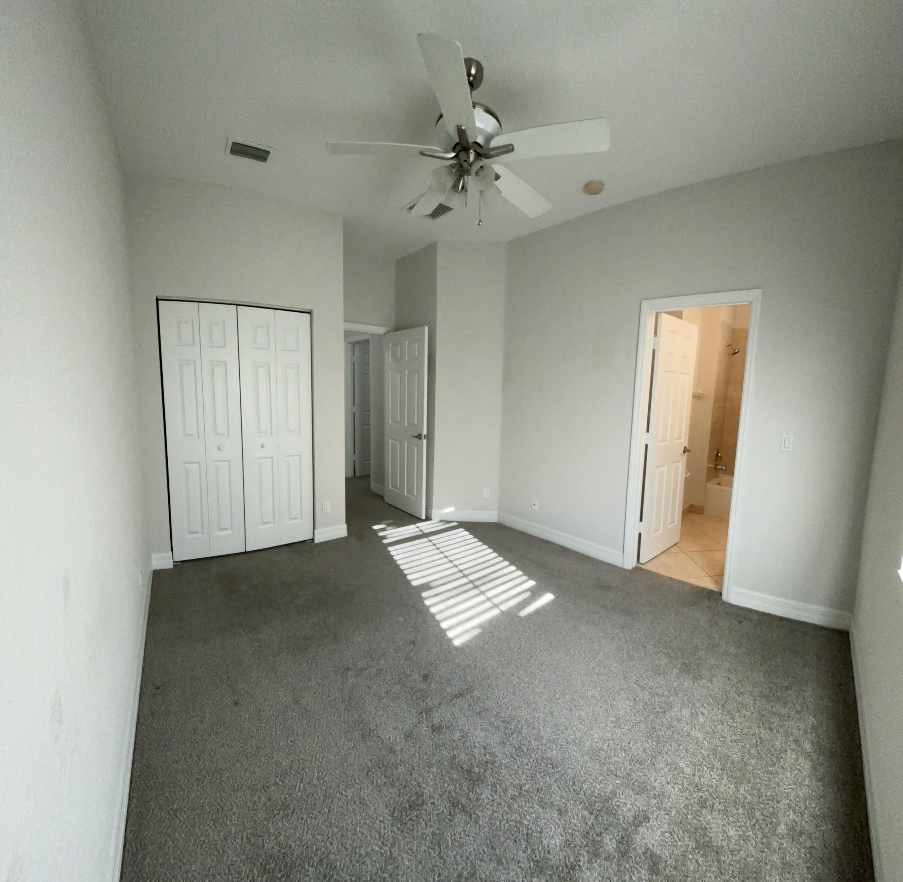 909 Northwest 18th Avenue Boca Raton, FL 33431 - Photo 26 of 39 an empty room with a ceiling fan and window