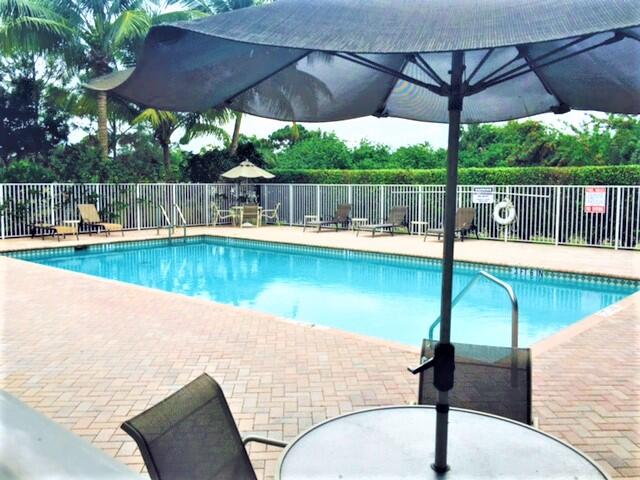 909 Northwest 18th Avenue Boca Raton, FL 33431 - Photo 32 of 39 a view of a swimming pool with a patio