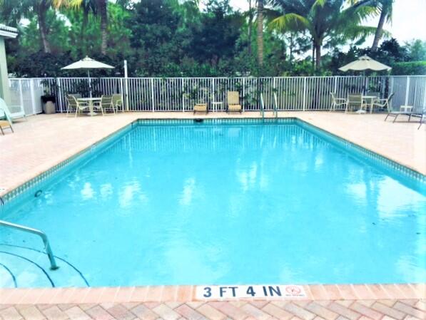909 Northwest 18th Avenue Boca Raton, FL 33431 - Photo 33 of 39 a view of a swimming pool with a patio