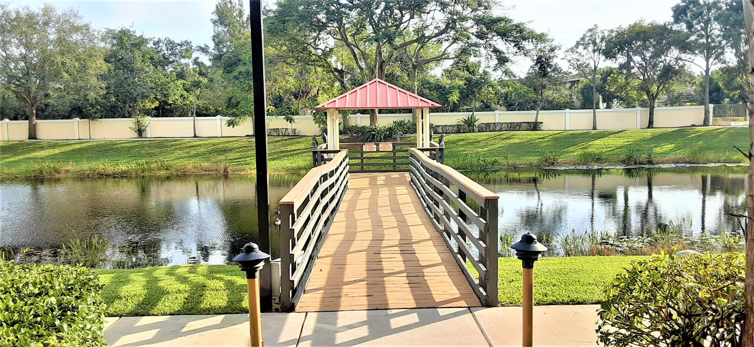 909 Northwest 18th Avenue Boca Raton, FL 33431 - Photo 36 of 39 a view of a lake with a house in the background
