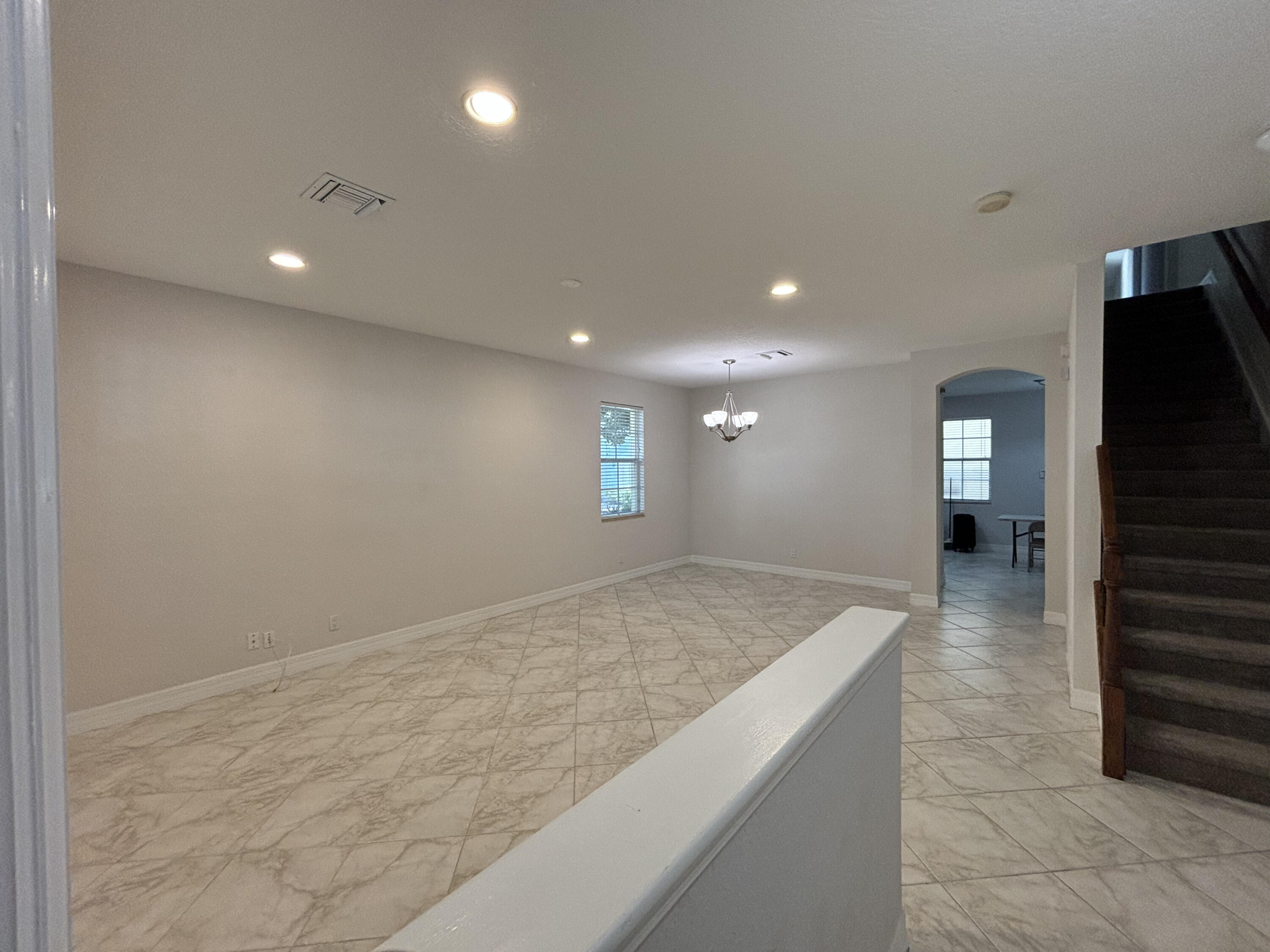 909 Northwest 18th Avenue Boca Raton, FL 33431 - Photo 4 of 39 a view of a hallway with wooden floor and staircase