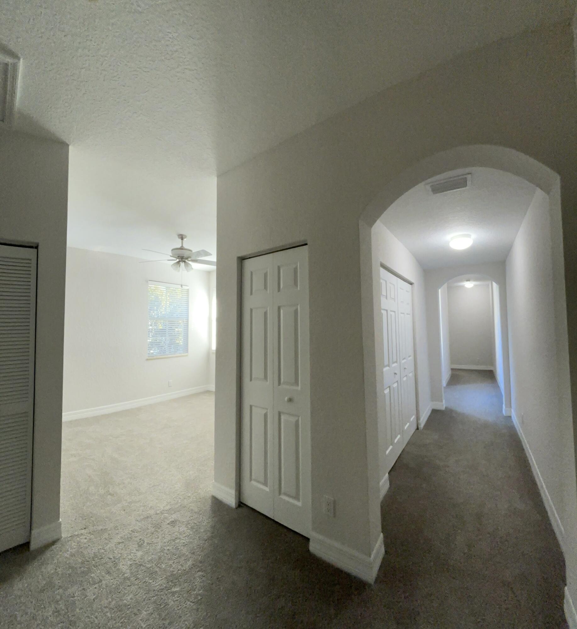 909 Northwest 18th Avenue Boca Raton, FL 33431 - Photo 10 of 39 a view of a hallway with wooden shelves