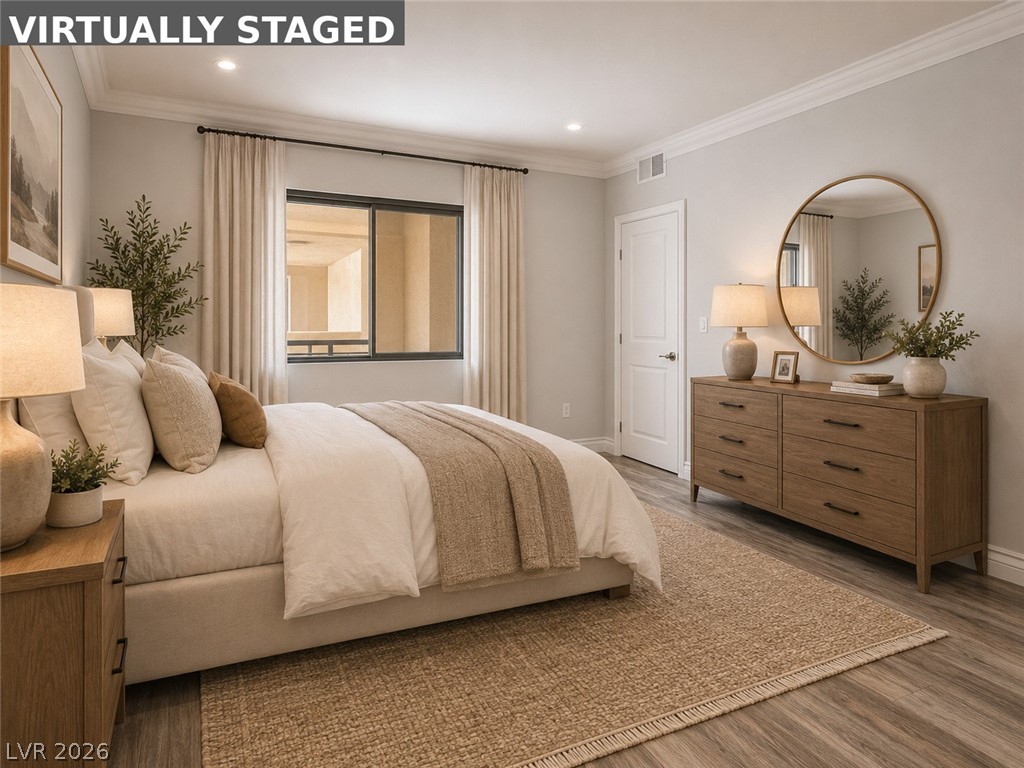 260 East Flamingo Road, Unit 220 Las Vegas, NV 89169 - Photo 30 of 32 Recessed lighting illuminates this inviting bedroom, featuring crown molding and light wood-tone flooring.