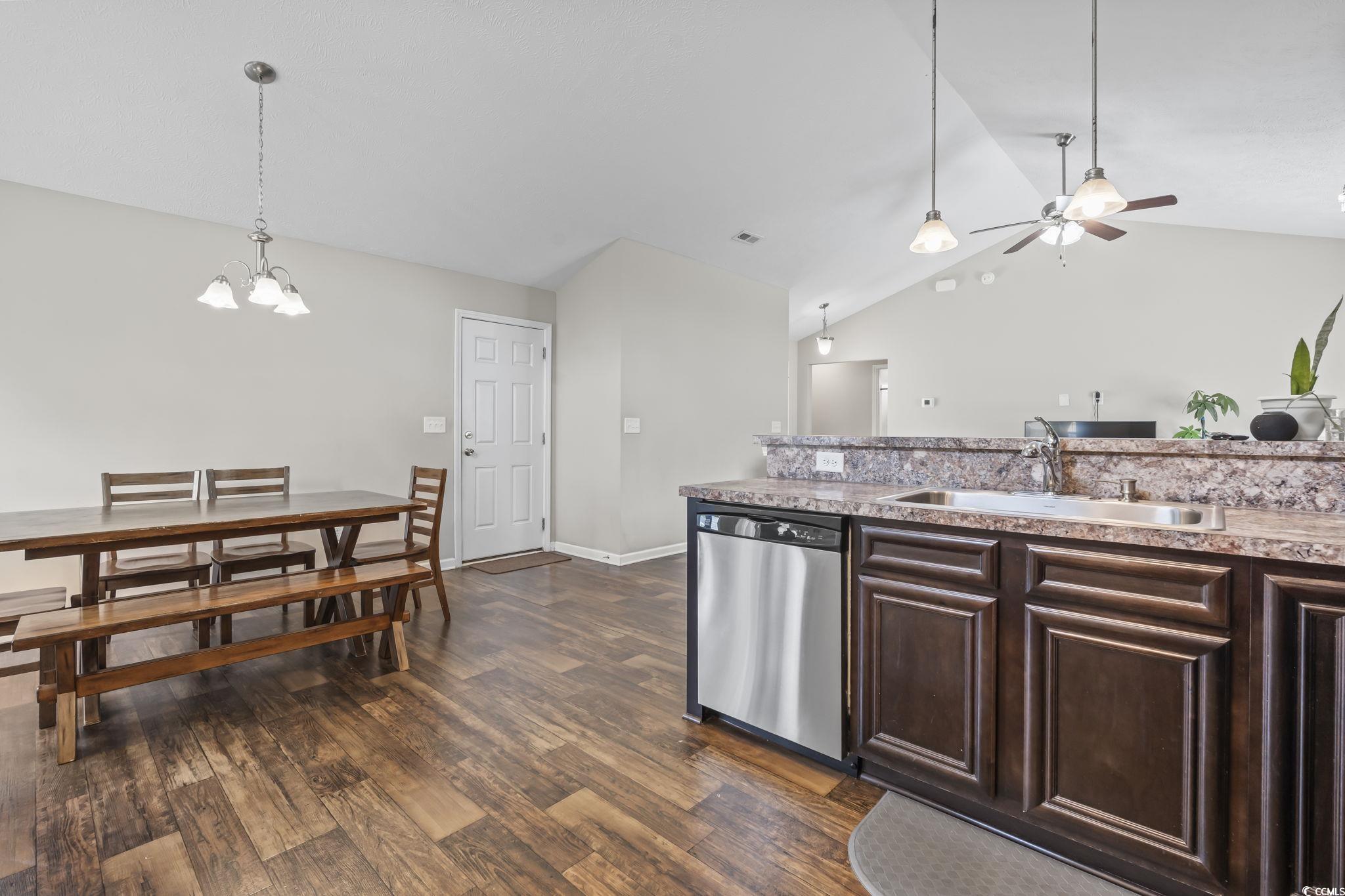 282 Foxpath Loop Myrtle Beach, SC 29588 - Photo 13 of 34 Kitchen featuring stainless steel dishwasher, a sink, vaulted ceiling, a ceiling fan, and dark brown cabinets