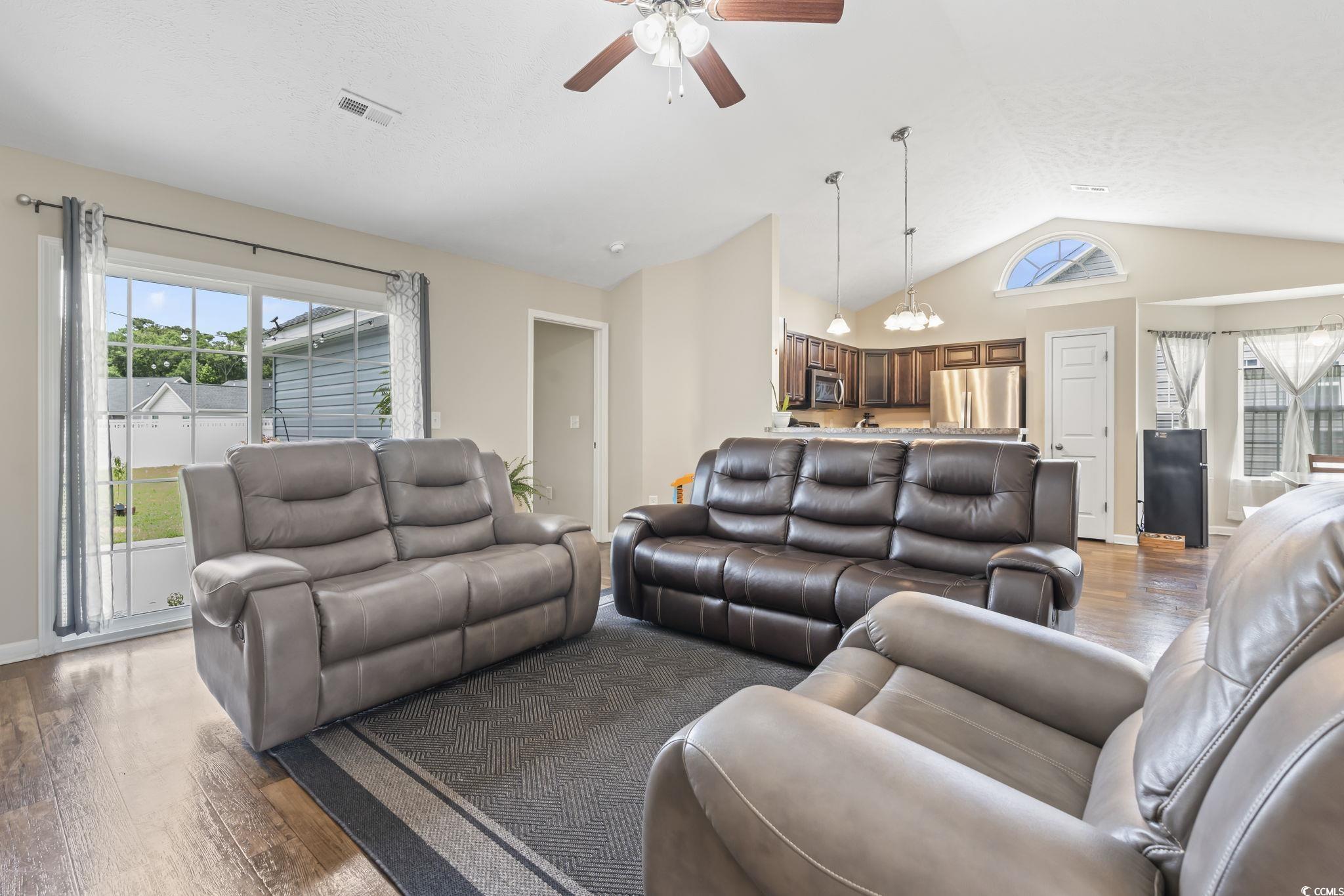 282 Foxpath Loop Myrtle Beach, SC 29588 - Photo 2 of 34 Living area with vaulted ceiling, light wood-style flooring, a ceiling fan, and a chandelier