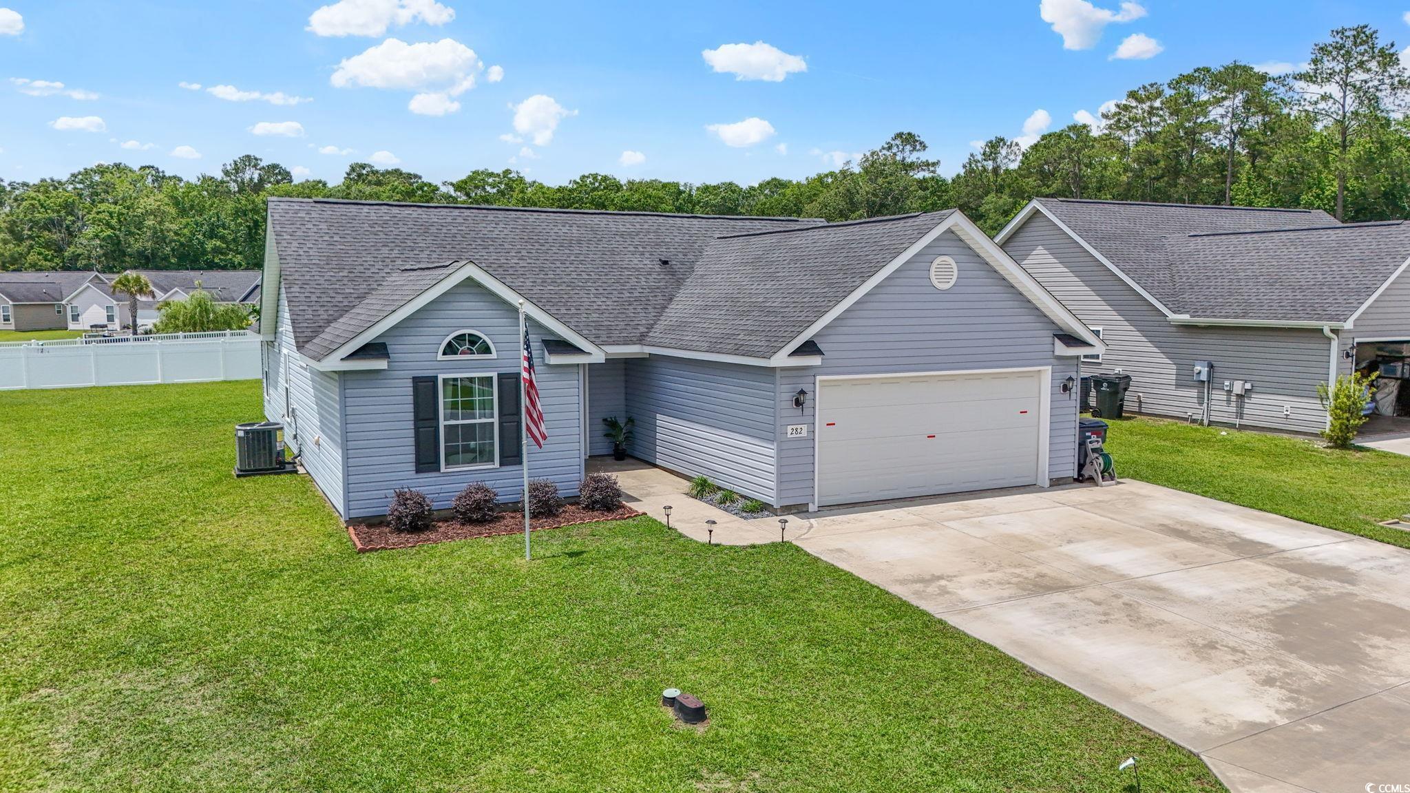 282 Foxpath Loop Myrtle Beach, SC 29588 - Photo 30 of 34 Ranch-style home featuring an attached garage, roof with shingles, driveway, and central AC unit
