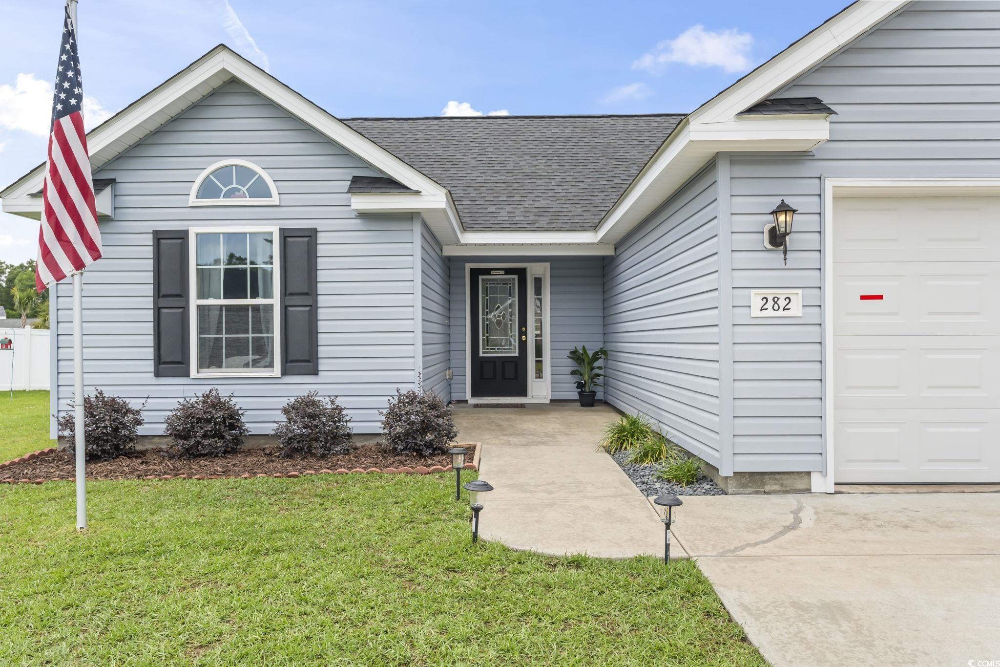282 Foxpath Loop Myrtle Beach, SC 29588 - Photo 6 of 34 View of front of property with an attached garage, roof with shingles, and a front yard