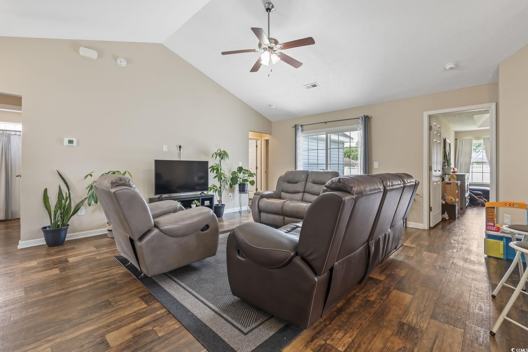 282 Foxpath Loop Myrtle Beach, SC 29588 - Photo 7 of 34 Living area featuring dark wood finished floors, a ceiling fan, vaulted ceiling, and baseboards