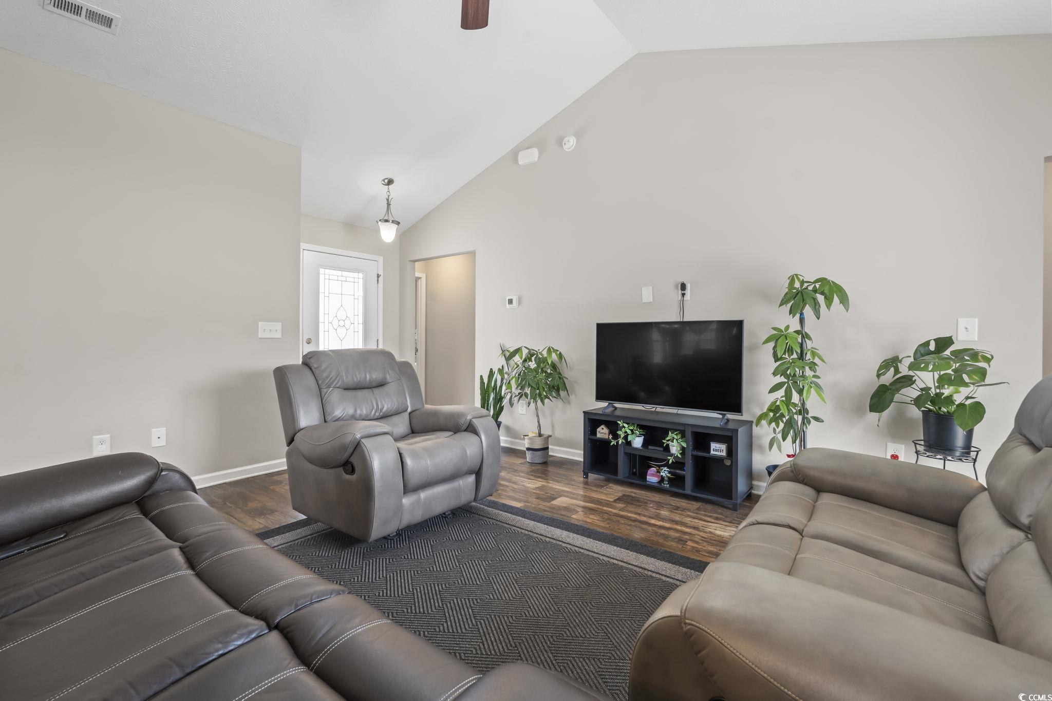 282 Foxpath Loop Myrtle Beach, SC 29588 - Photo 8 of 34 Living room with dark wood finished floors, vaulted ceiling, baseboards, and ceiling fan