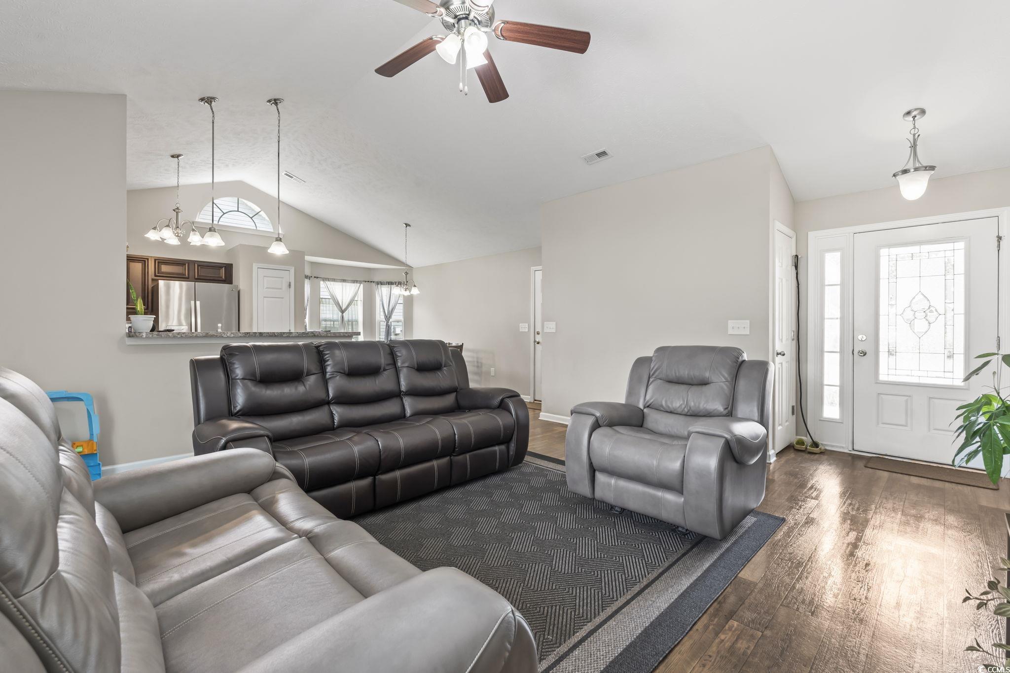 282 Foxpath Loop Myrtle Beach, SC 29588 - Photo 9 of 34 Living area featuring dark wood finished floors, a ceiling fan, lofted ceiling, baseboards, and a chandelier