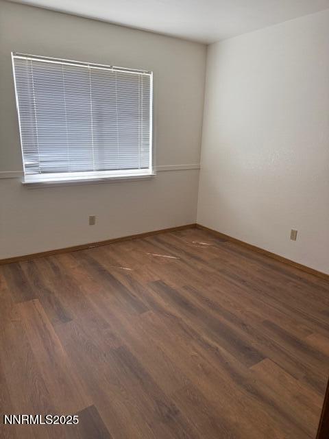 1825 Chelcie Street Fallon, NV 89406 - Photo 4 of 6 an empty room with wooden floor and windows