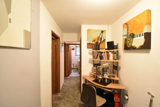 a view of a livingroom with furniture and workspace