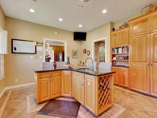 a kitchen with stainless steel appliances granite countertop a sink and a refrigerator