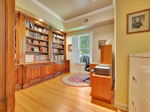 a bedroom with furniture and a book shelf