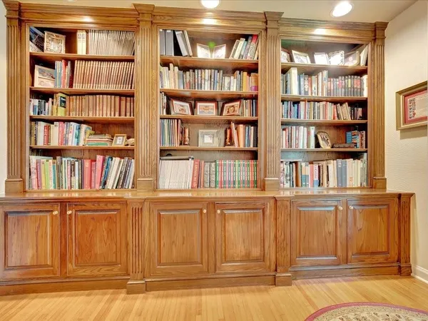 a view of a living room that has a book shelf