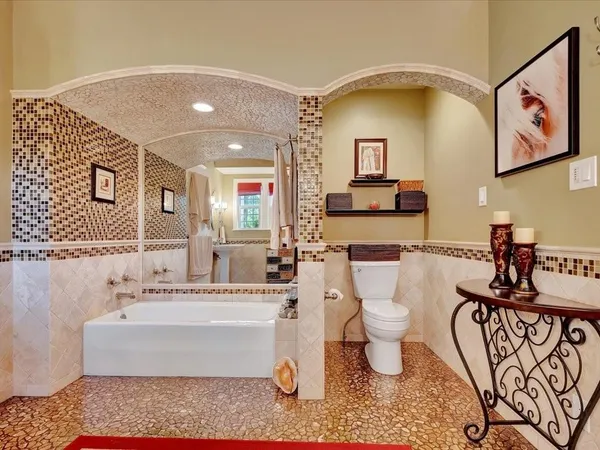 a bathroom with a bathtub sink and toilet