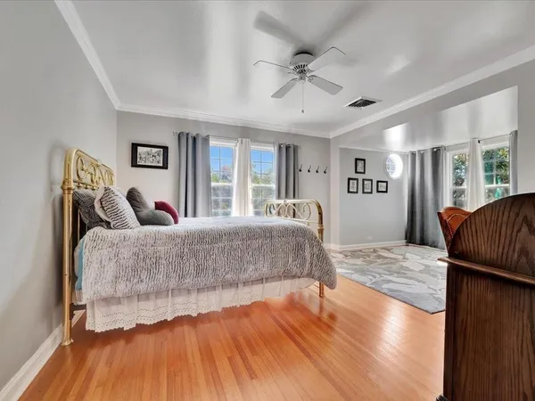 a view of a livingroom with wooden floor and a large window