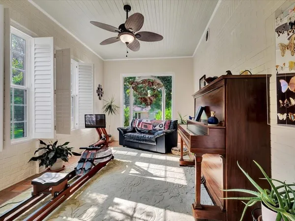 a living room with furniture ceiling fan and a rug