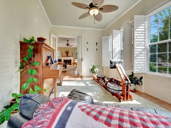 a bedroom with furniture and a wooden floor