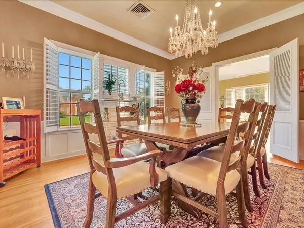 a view of a dining room with furniture wooden floor and chandelier