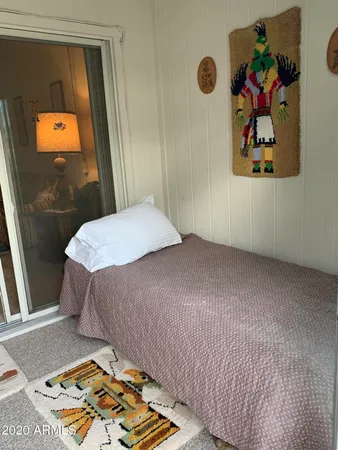 a bedroom with a bed and a mirror