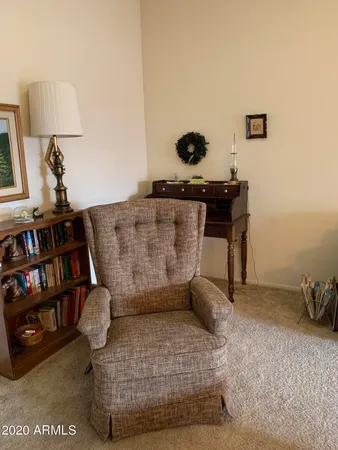 a living room with furniture and a book shelf
