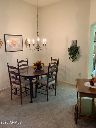 a dining room with furniture and a chandelier