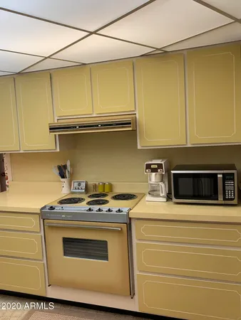 a kitchen with stainless steel appliances granite countertop a stove and a microwave