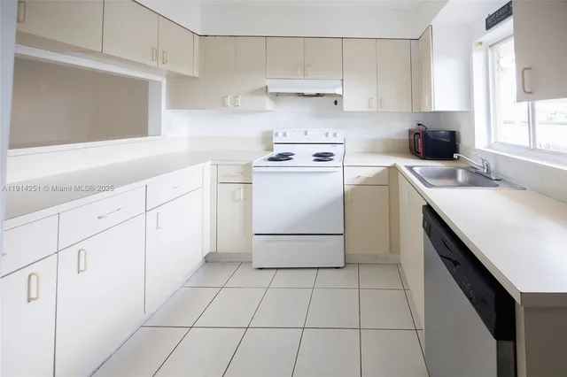 a kitchen with a stove a sink and a refrigerator