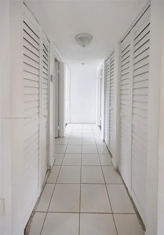 a view of a livingroom with an empty space and a window