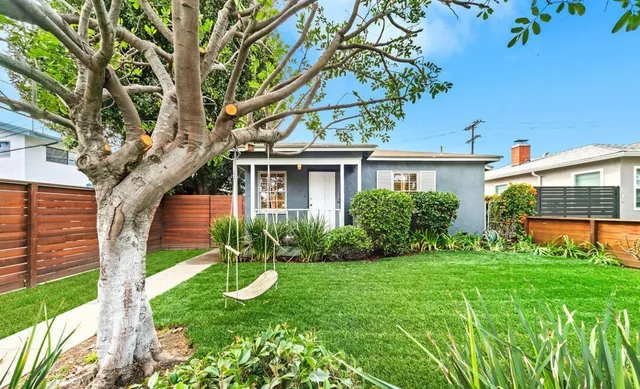 a view of house with a yard