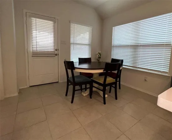 a view of a dining room with furniture and window