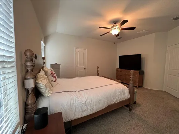 a bedroom with a bed and a tv