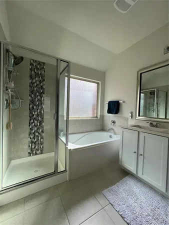 a spacious bathroom with a bathtub and a shower