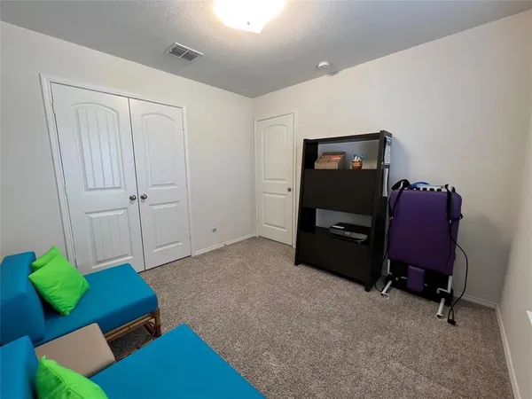 a living room with furniture and a chair