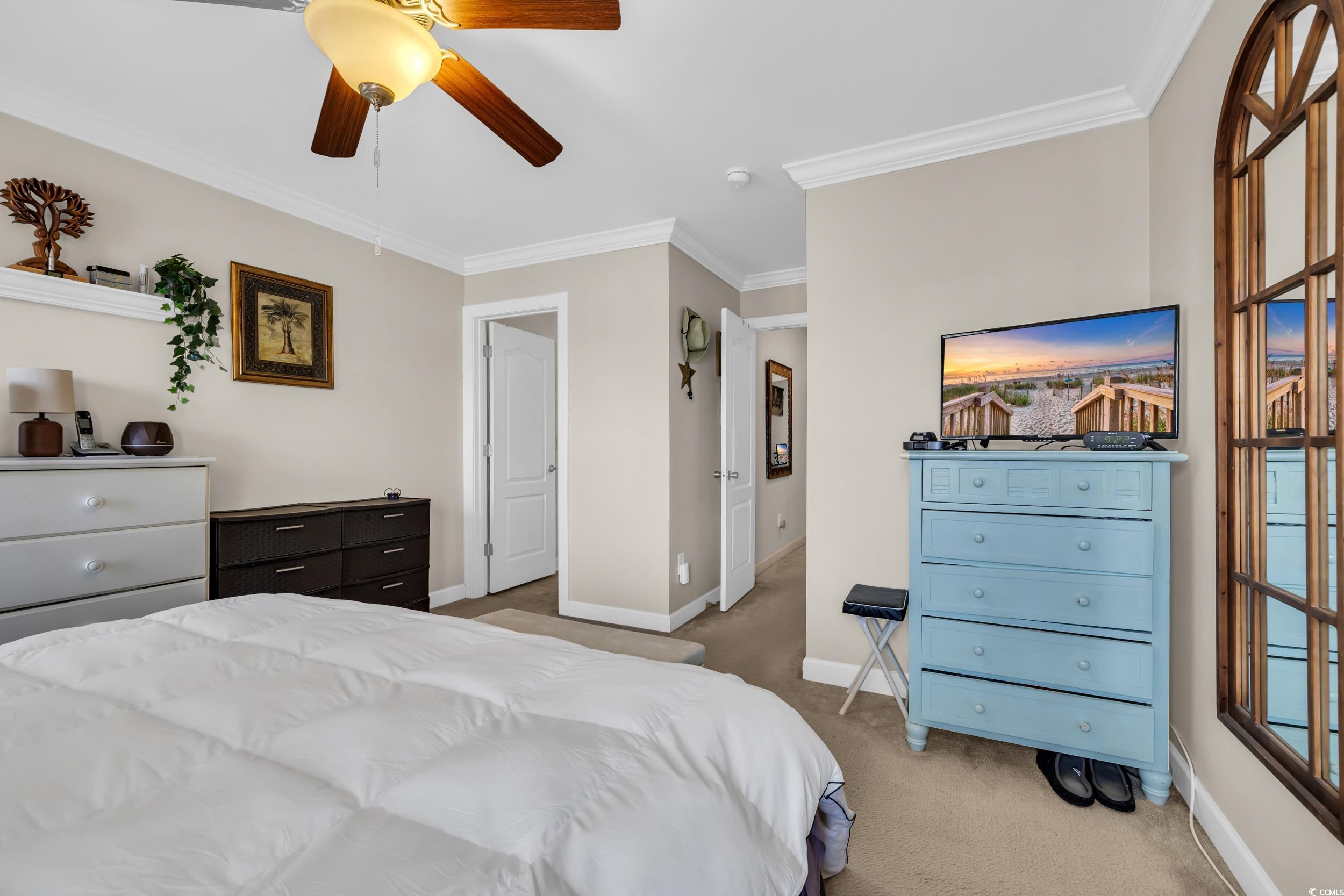 1040 Fairway Lane, Unit 1040 Conway, SC 29526 - Photo 15 of 28 Bedroom featuring ornamental molding, ceiling fan, and dark carpet