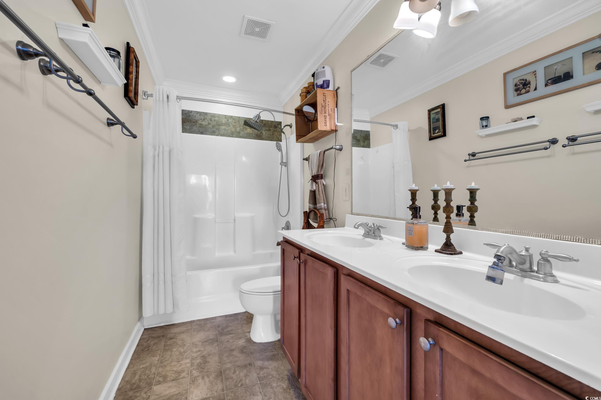 1040 Fairway Lane, Unit 1040 Conway, SC 29526 - Photo 17 of 28 Full bathroom with shower / bath combo, ornamental molding, vanity, and toilet