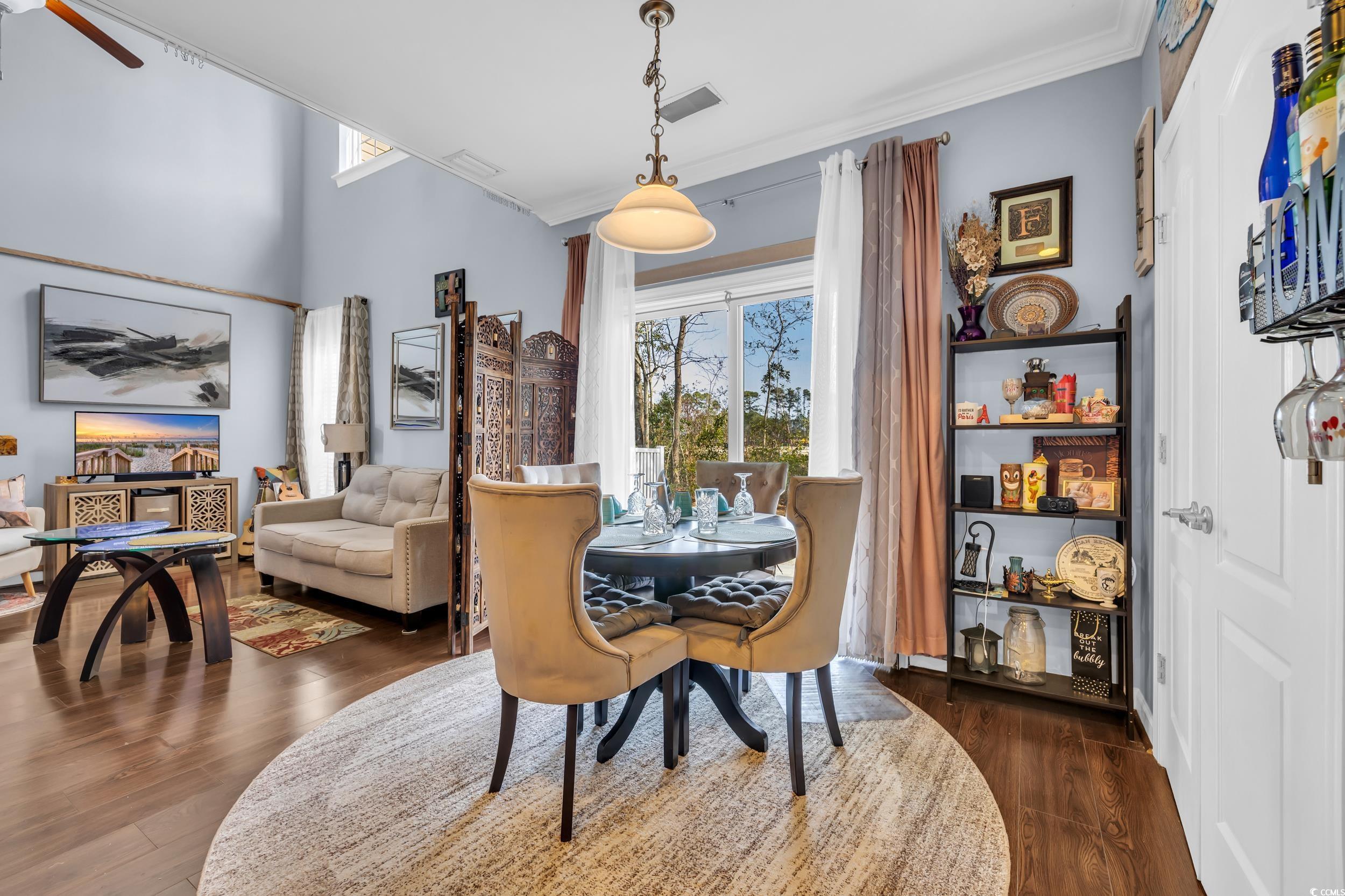 1040 Fairway Lane, Unit 1040 Conway, SC 29526 - Photo 8 of 28 Dining space with dark wood-type flooring, ornamental molding, and a healthy amount of sunlight