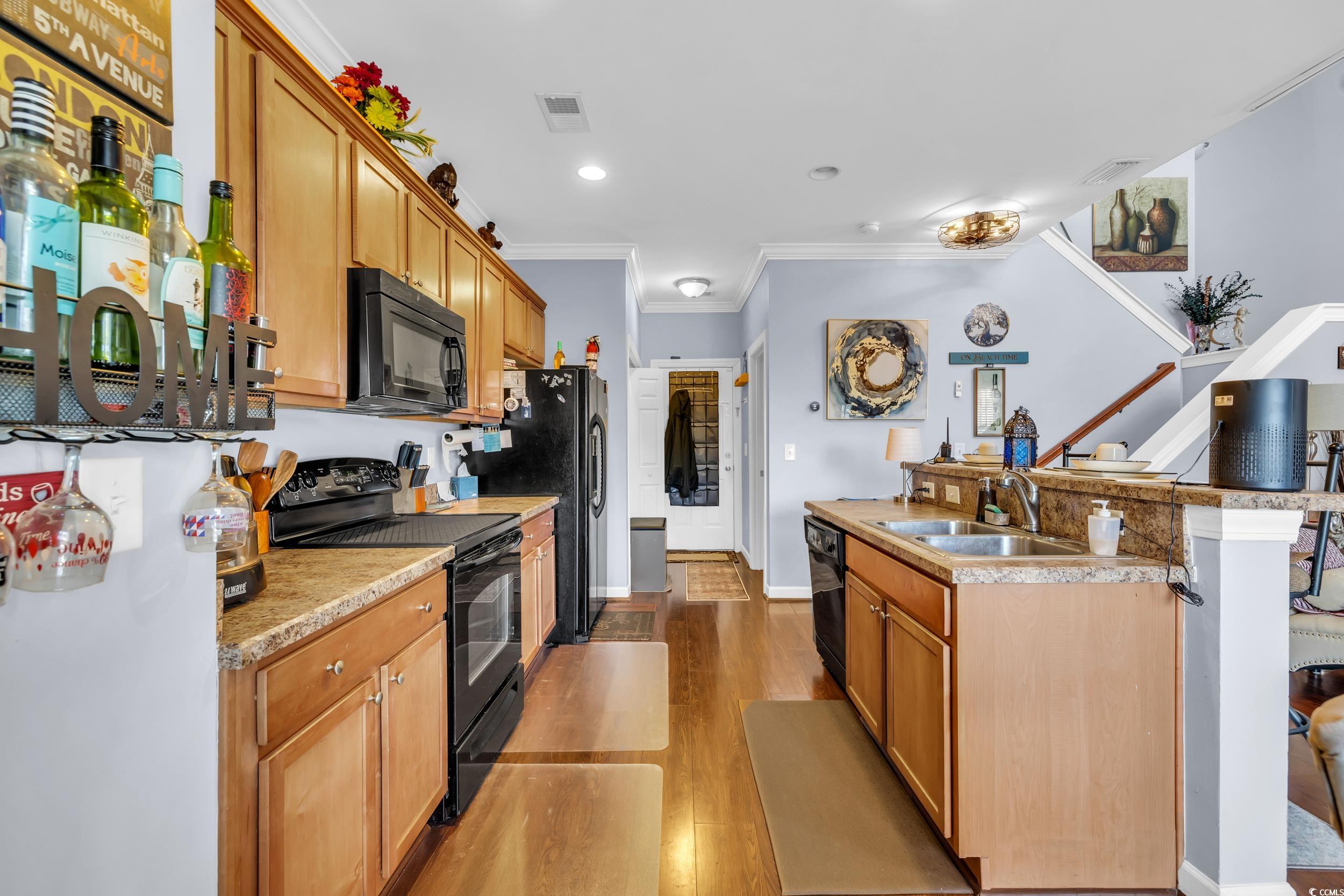 1040 Fairway Lane, Unit 1040 Conway, SC 29526 - Photo 9 of 28 Kitchen with sink, crown molding, black appliances, and light wood-type flooring