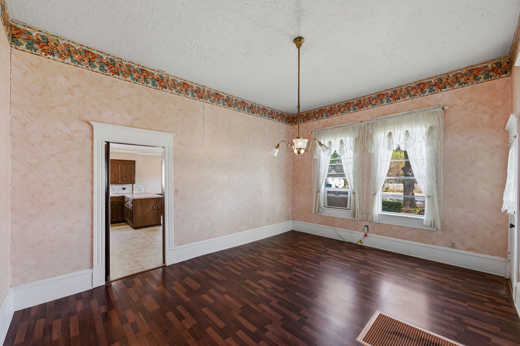 100 West 11th Street Elgin, TX 78621 - Photo 11 of 32 a view of an empty room with wooden floor and a window