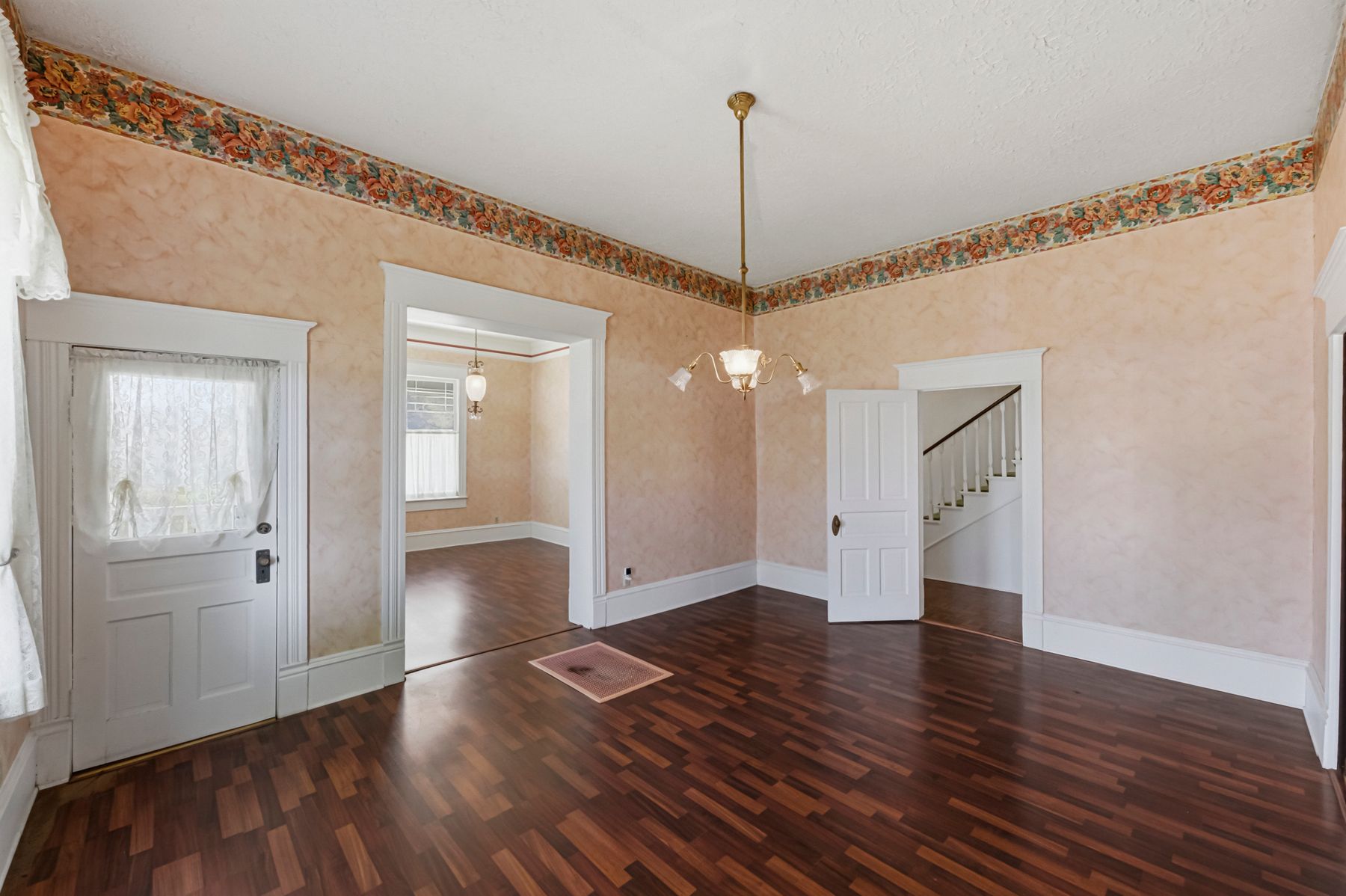 100 West 11th Street Elgin, TX 78621 - Photo 12 of 32 a view of an empty room with wooden floor closet and a living room