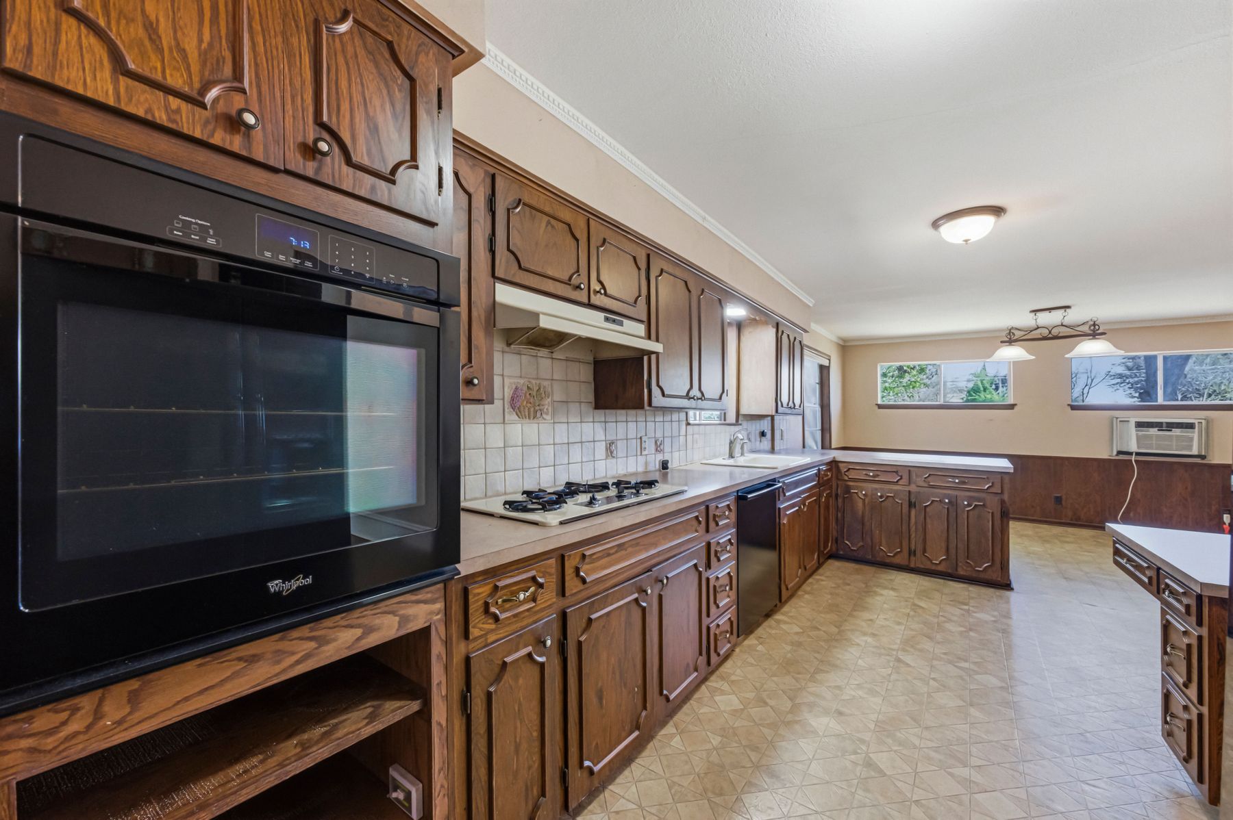 100 West 11th Street Elgin, TX 78621 - Photo 13 of 32 a kitchen with stainless steel appliances a stove and cabinets